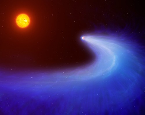 This artist's impression shows exoplanet GJ 436b, which is surrounded by a massive gas cloud that streams behind the planet like a comet's tail for millions of miles. Credit: Mark Garlick/University of Warwick