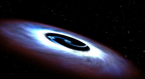 Illustrazione artistica del sistema binario di buchi neri nel nucleo di Mrk 231. Come una coppia di pattinatori che si muovono spiraleggiando, i due buchi neri generano una enorme quantità di energia che rende brillante il nucleo. Credit: NASA, ESA, and G. Bacon (STScI)